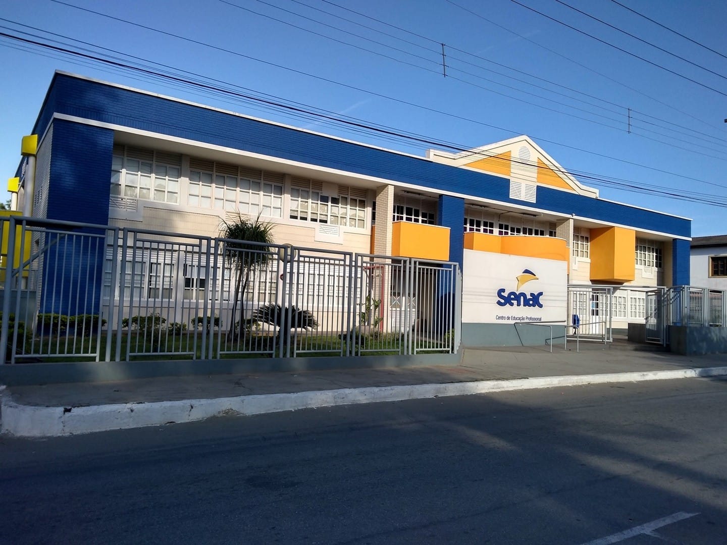 Fachada azul, branca e amarela do Centro de Educação Profissional do Senac em Coronel Fabriciano
